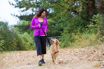 Dog training Cork: woman using positive reinforcement with a retriever on a loose lead